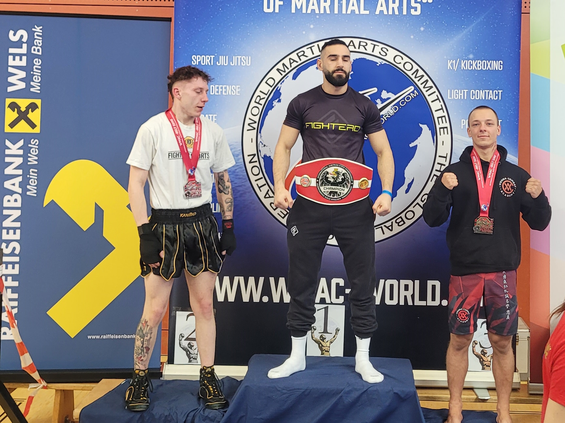 Coach Anton on a podium with his bronze medal