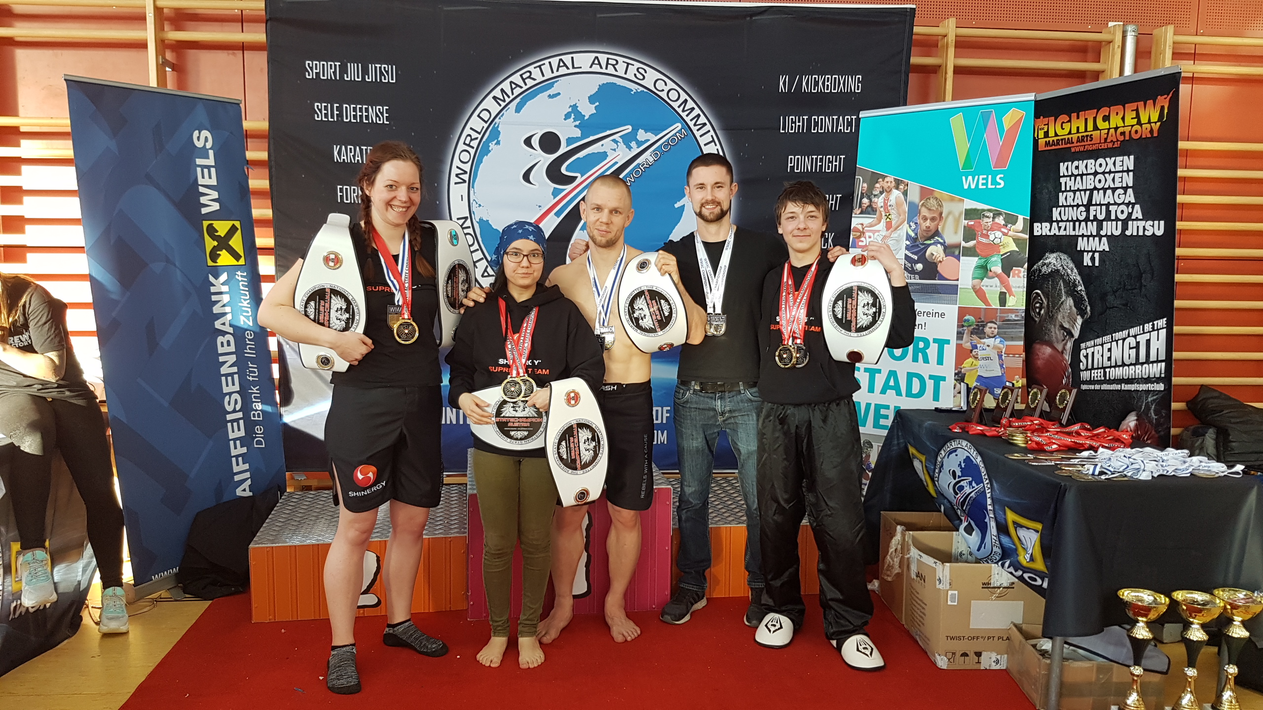 Five fighters posing with their medals