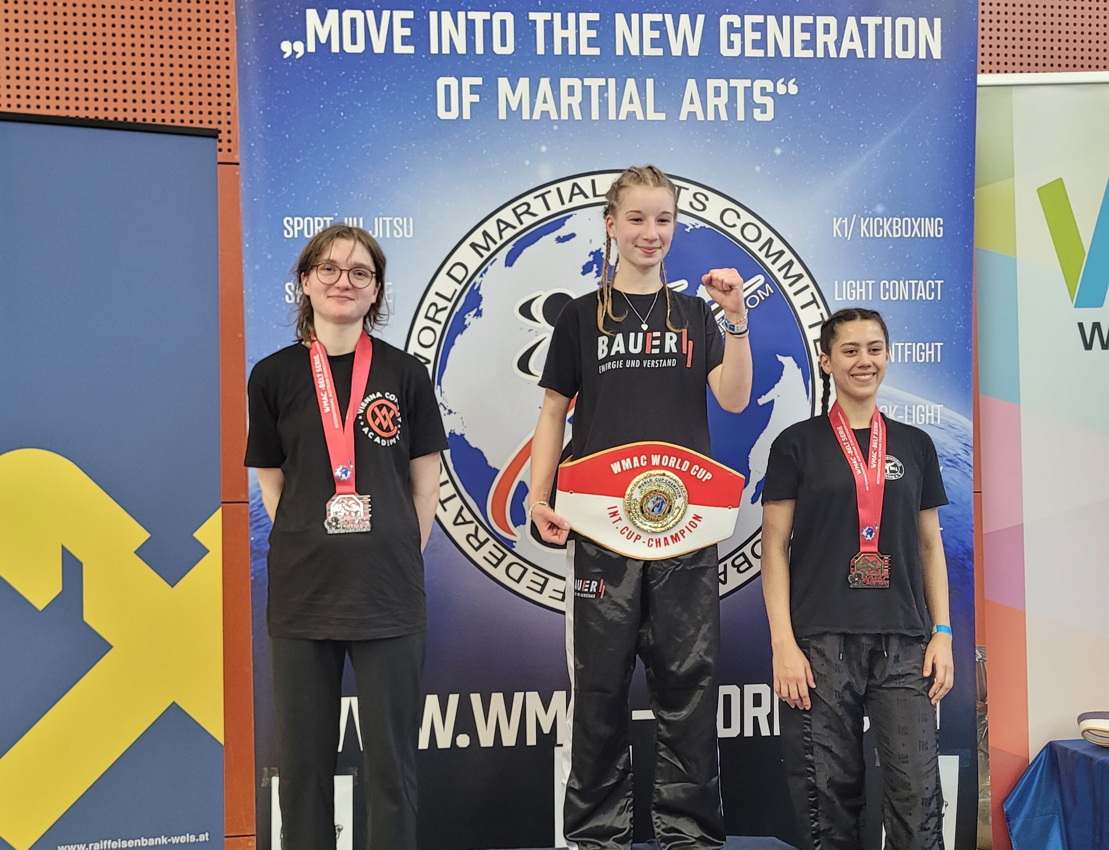 Three female fighters posing with their medals